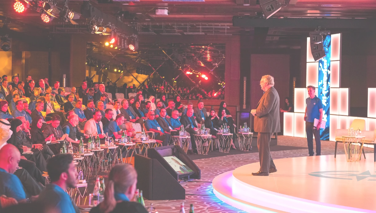 Corporate event setup with professional branding, elegant stage design, and audience seating